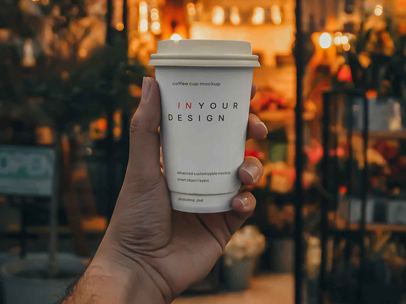 Free Coffee Cup in Hand Mockup