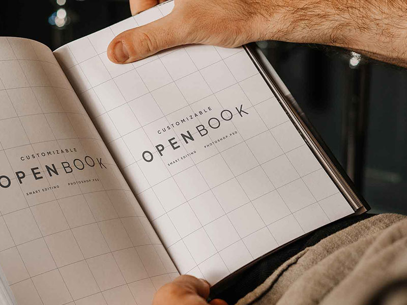 Free Opened Book in Hand Mockup