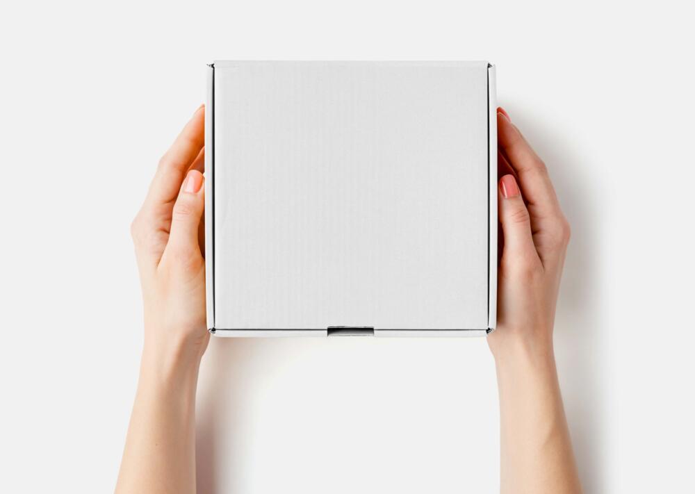 Woman's Hand Holding Square Box Mockup