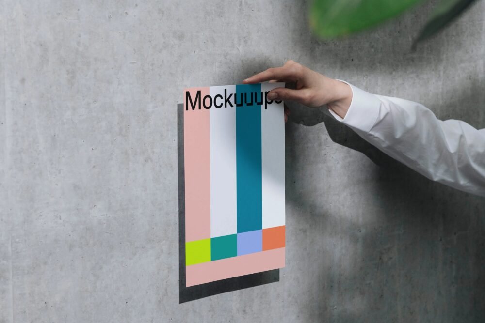 A4 mockup held against a concrete wall