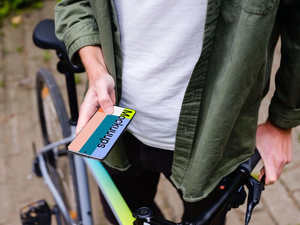 Holding Samsung S20 mockup in front of a bike