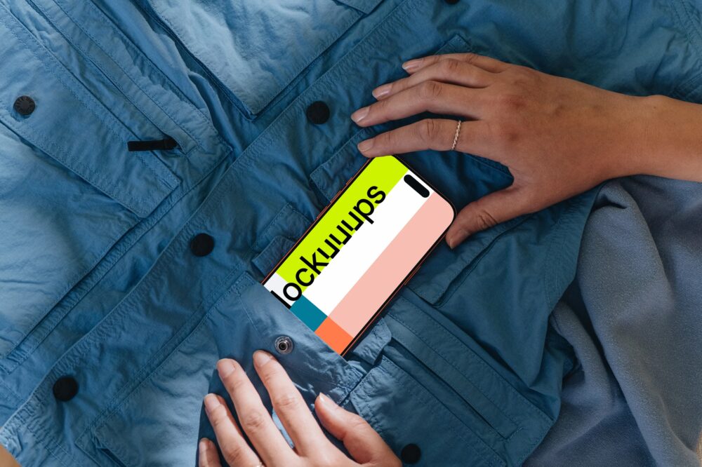 iPhone 17 Pro mockup with hand on blue jacket