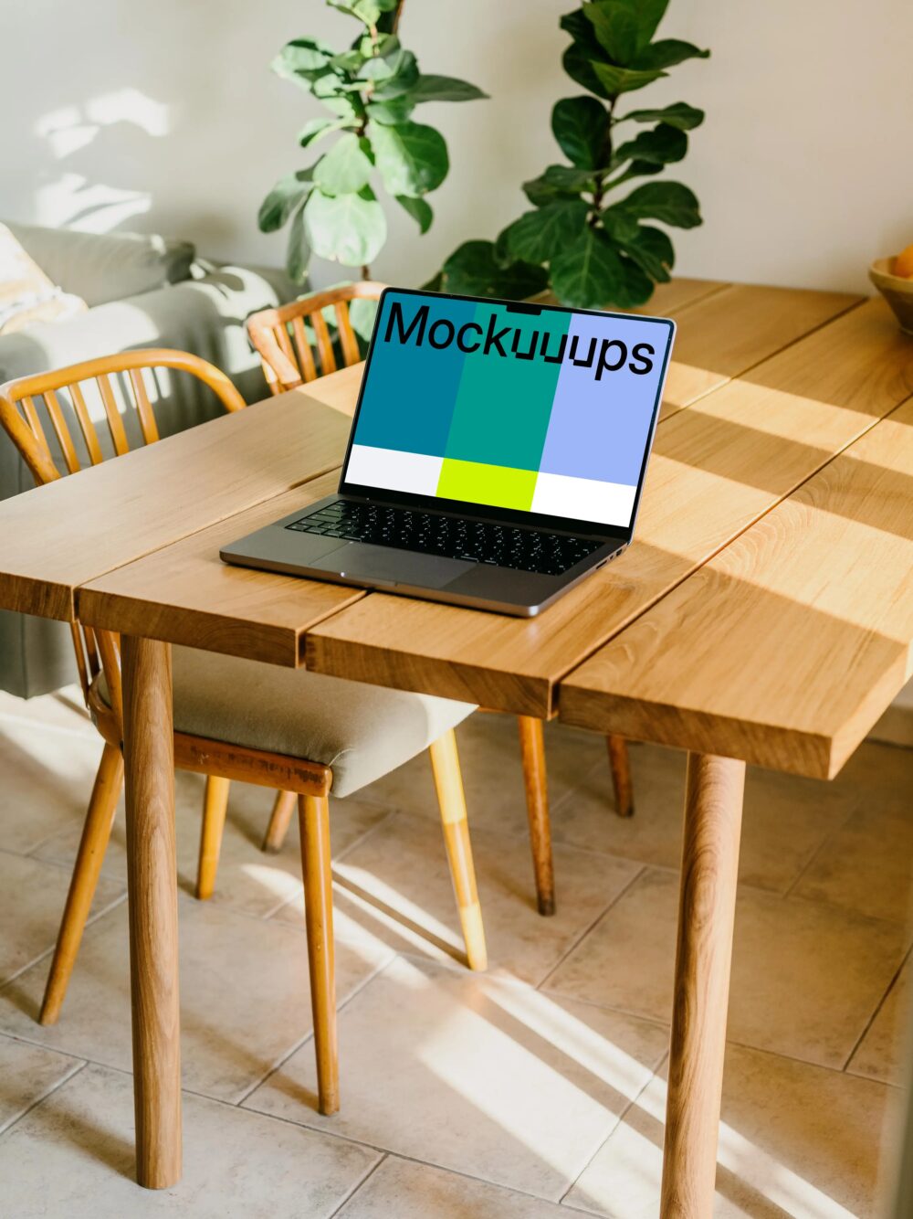 MacBook Pro mockup on a table with a plant in the background